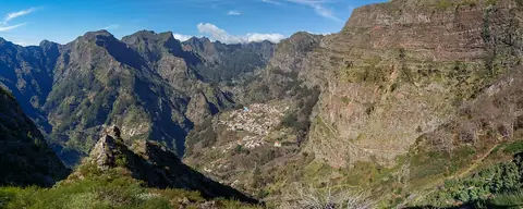 Mountain walls around Curral das Freiras viewed from Eira do Serrado, showing the valley below the lookout.
